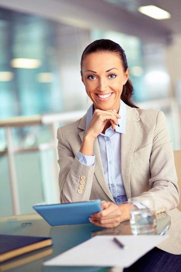 Portrait of confident employee with touchpad looking at camera